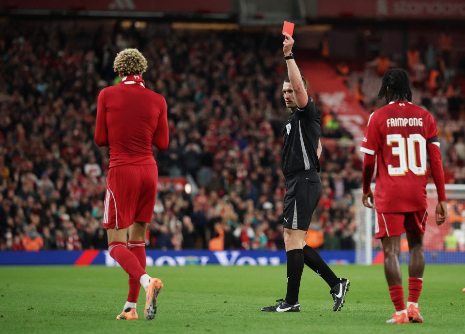 Referee Thomas Bramall shows Liverpool's Hugo Ekitike a red card.