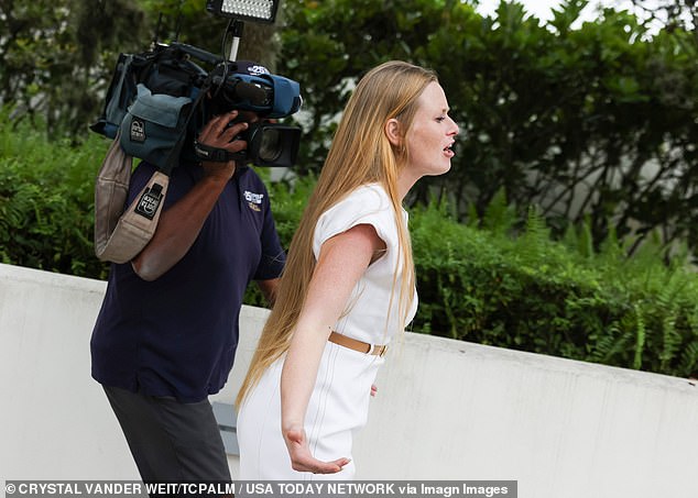 Separate footage captured her waiting by the back gates as several police cars filed out of the building