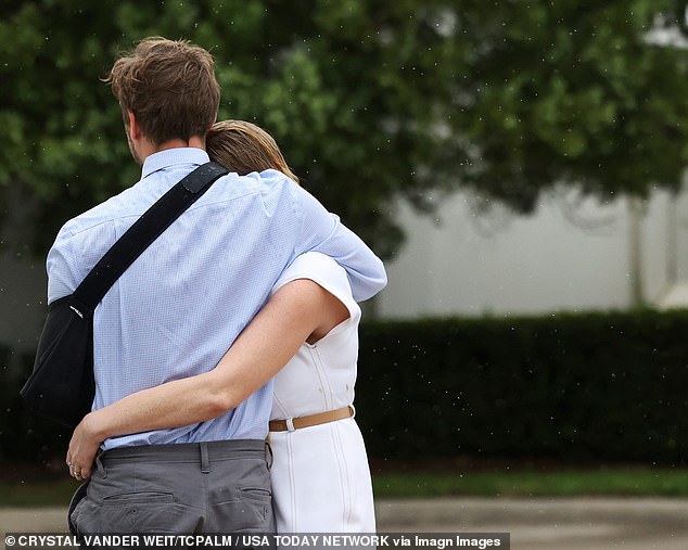 She sought comfort in the arms of her brother Adam as they waited for their father to be transferred to prison