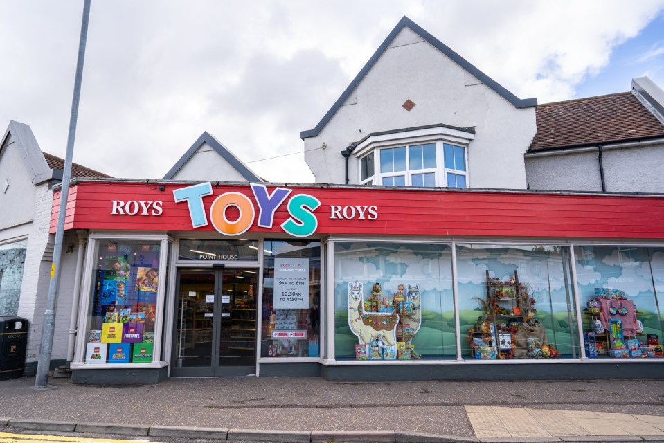 Roy's Toys store with a red facade and large window displays of toys.
