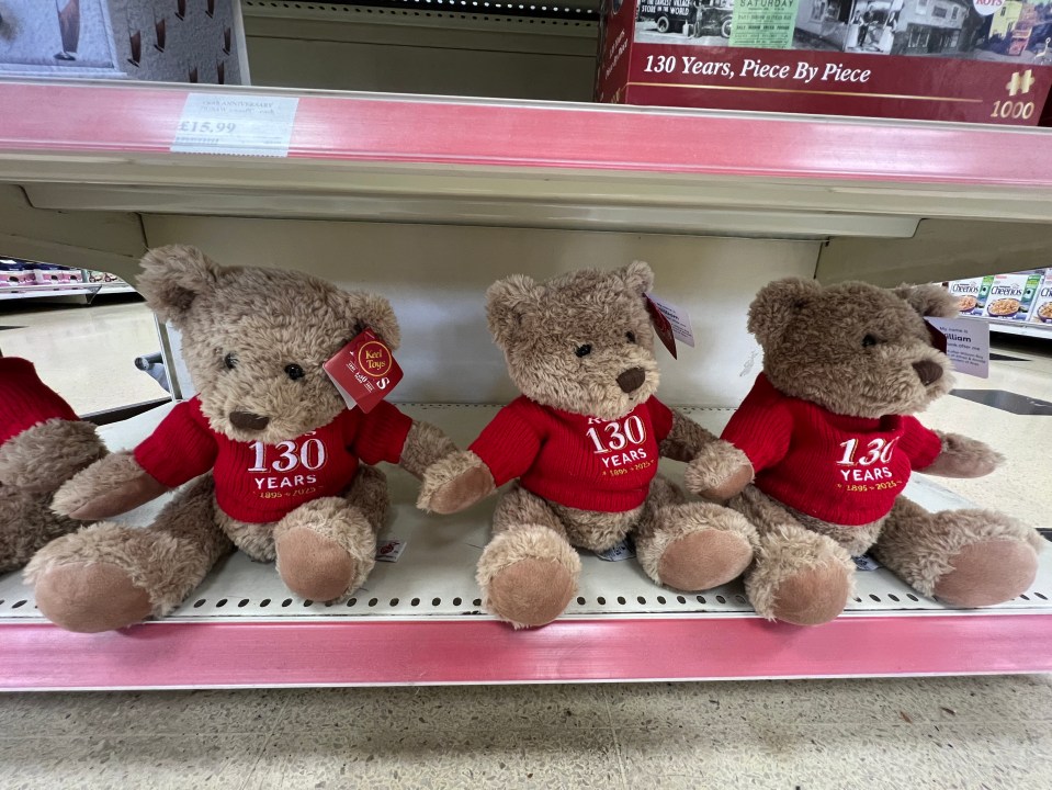 Three Roy's of Wroxham 130th-anniversary teddy bears sitting on a shelf.