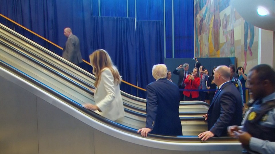 Donald Trump and Melania Trump on an escalator that stopped at UN Headquarters.