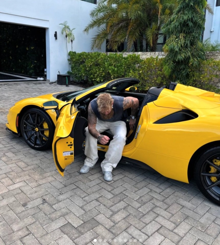 a man is getting out of a yellow sports car
