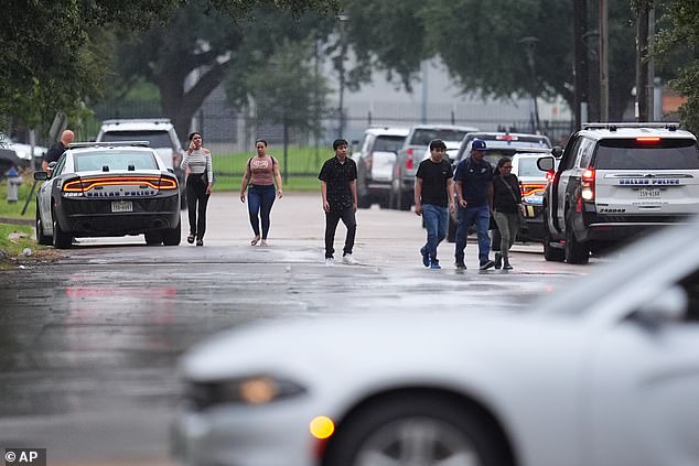 People who had appointments at a U.S. Immigration and Customs Enforcement office are turned away after a reported shooting in the facility in Dallas on Wednesday, Sept. 24, 2025. (AP Photo/Julio Cortez)
