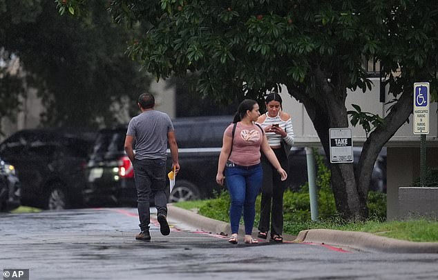 People who had appointments at a U.S. Immigration and Customs Enforcement office are turned away after a reported shooting in the facility in Dallas on Wednesday, Sept. 24, 2025. (AP Photo/Julio Cortez)