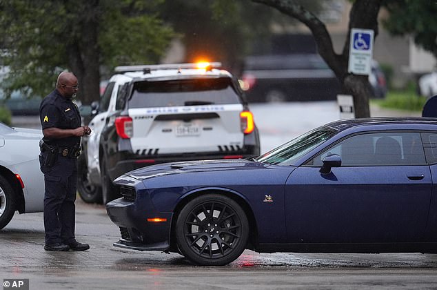 Police block off the street close to a U.S. Immigration and Customs Enforcement office after a reported shooting, in Dallas on Wednesday, Sept. 24, 2025. (AP Photo/Julio Cortez)