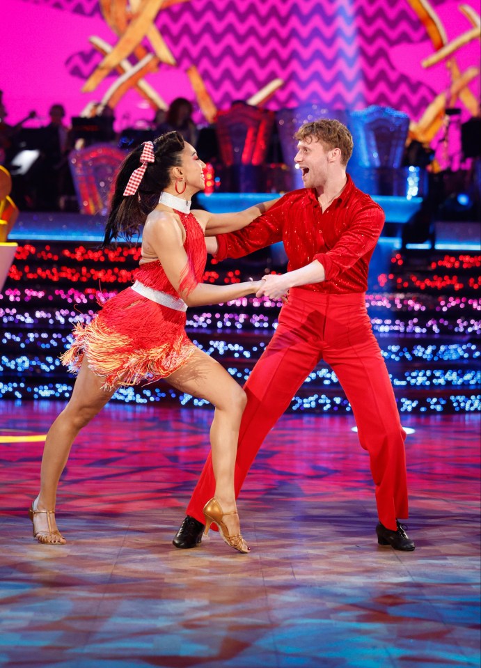 Jamie Borthwick and Michelle Tsiakkas dancing in red outfits on Strictly Come Dancing.
