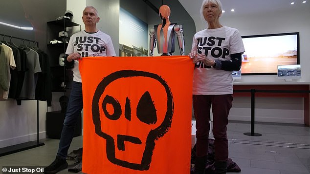 Nash and Nigel Fleming, 63, poured orange paint over the futuristic robot and declared they were fighting fascists