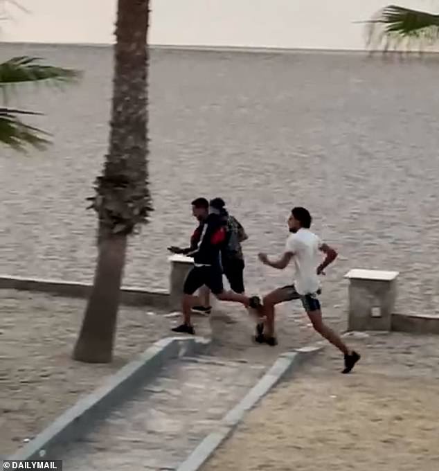 In a video shared exclusively with the Daily Mail, between 10 to 15 migrants jumped off the boat and swam to the beach, before running in the direction of the hotel