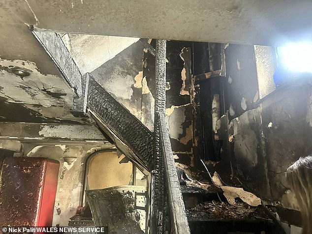 The house is destroyed, as a staircase is seen obliterated after the blaze