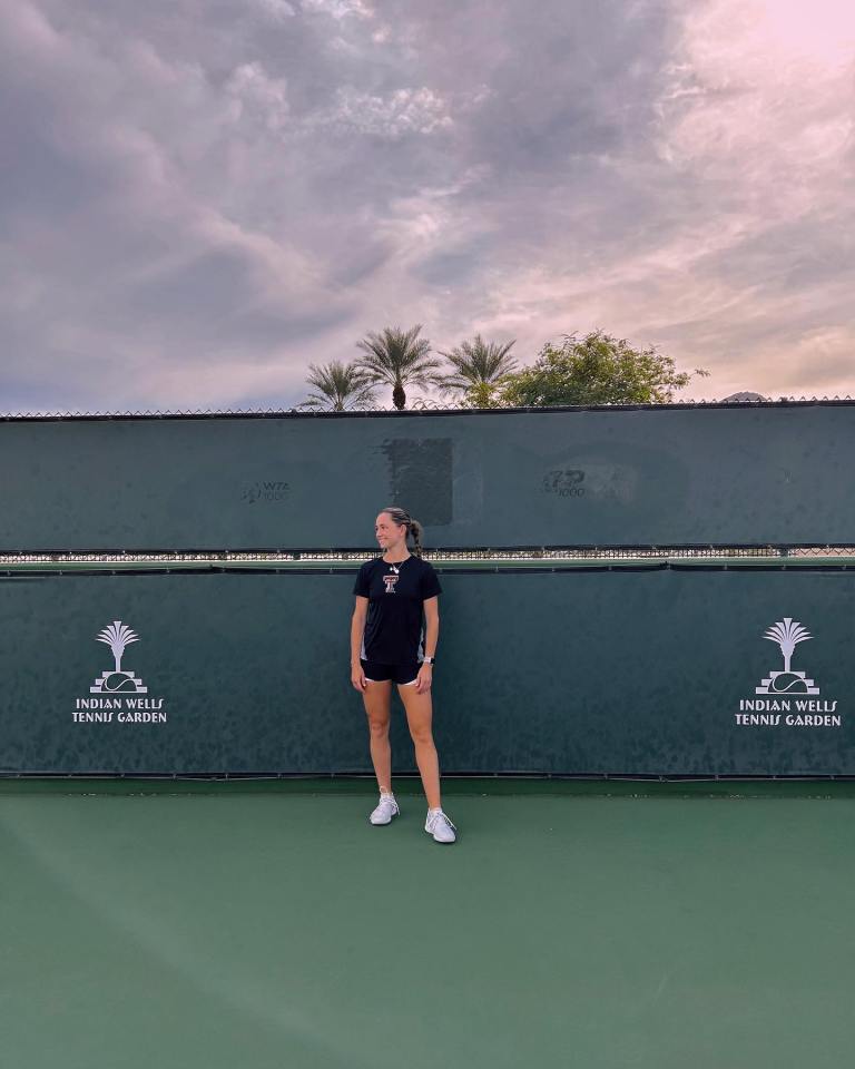 Olivia Peet, a British tennis player, standing on a tennis court.