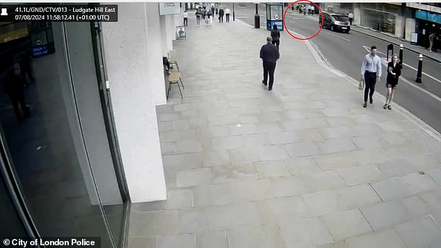 Duarte can be seen in the distance via CCTV footage as he is knocked off his bike by a member of the public