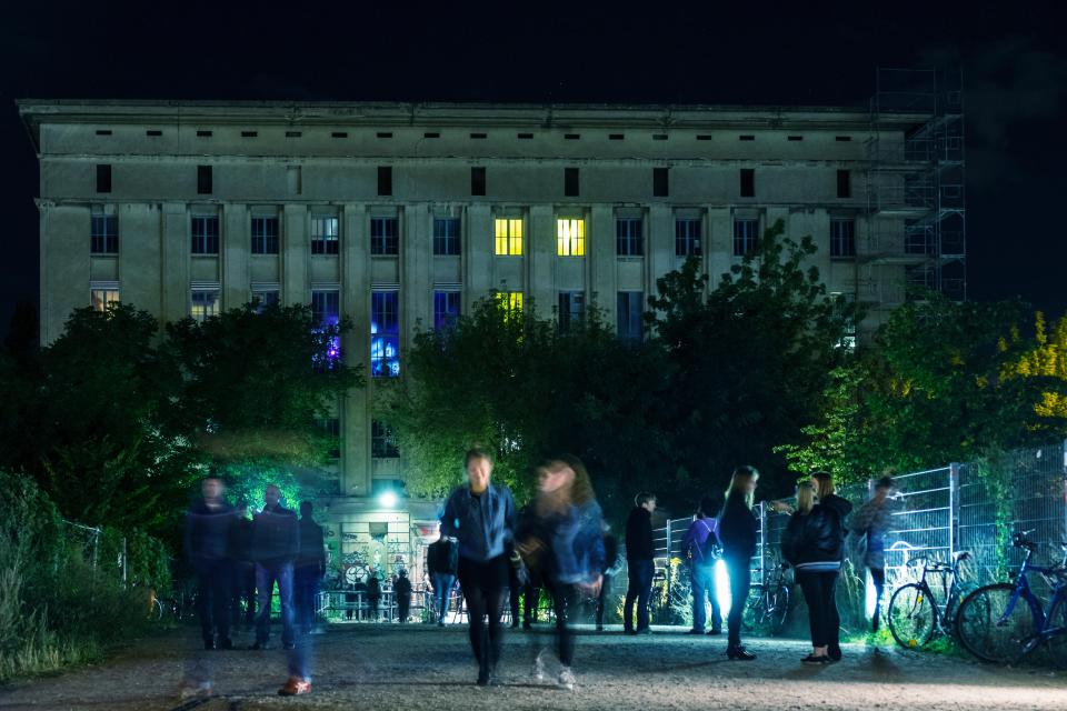 View at night of people waiting outside entrance to famous Berghain nightclub in Friedrichshain Berlin Germany.