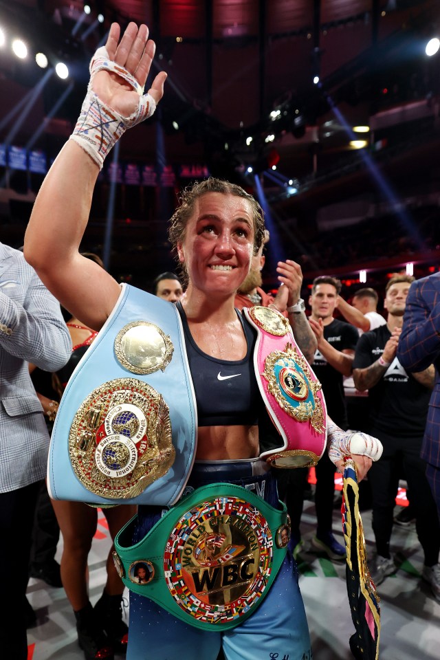Ellie Scotney celebrates a boxing victory with championship belts.
