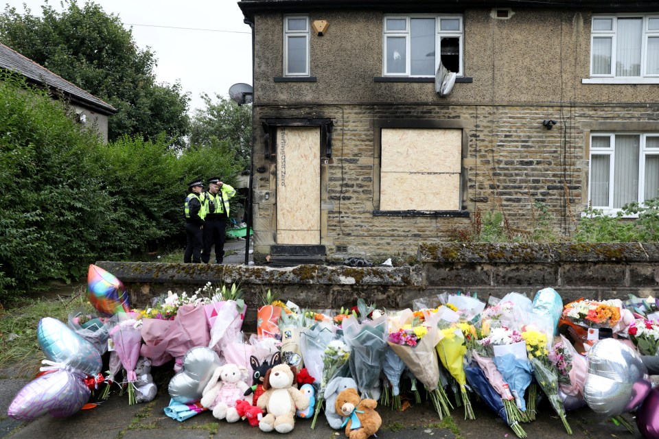 Floral tributes and stuffed animals outside the house where Bryonie Gawith and her three children died in a house fire.
