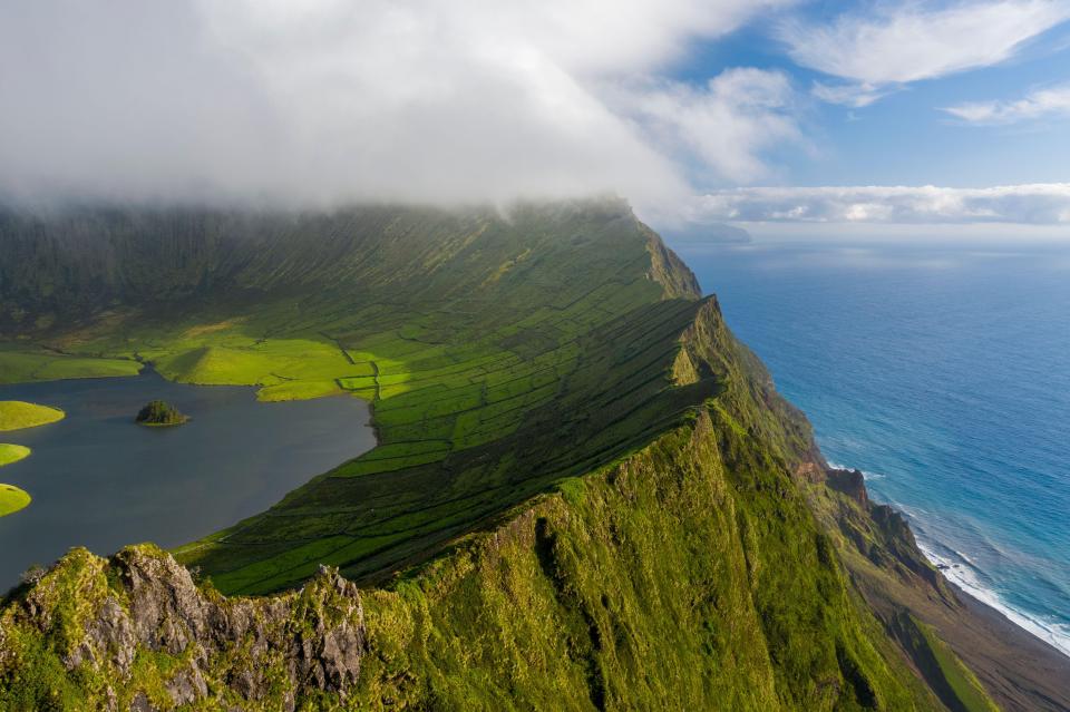Aerial view of Caldeirao lake along the coastline on Corvo island, Azores islands, Portugal.