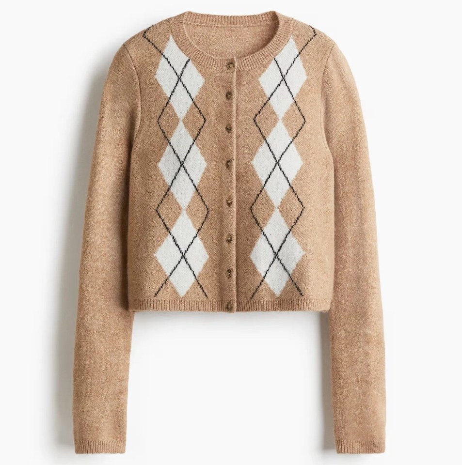 Cropped tan cardigan with white and black argyle pattern.