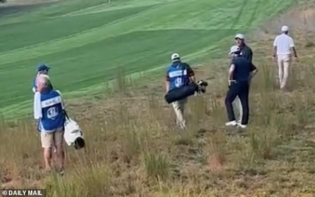 Brooklyn (third from right) and others spent over the allowed three minutes searching through shrubbery for his lost ball after a poor swing saw it dramatically swerve into golfing oblivion