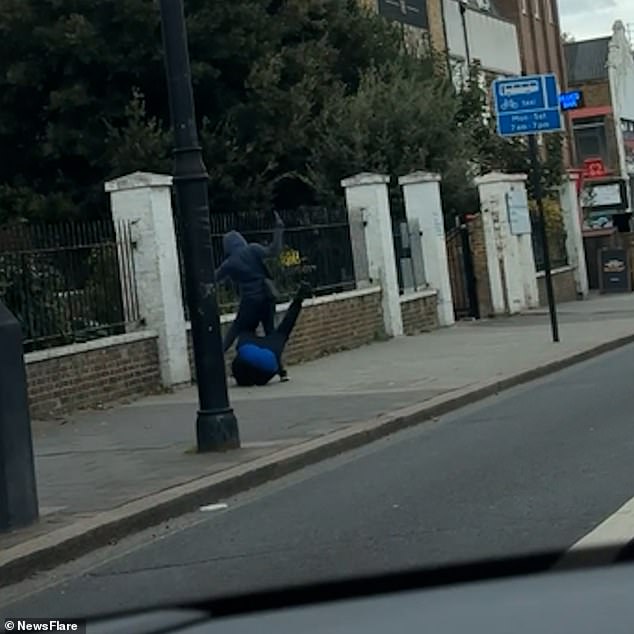 The victim then seems to lose his balance and falls to the ground, before the knife-wielding youth targets another member of the group