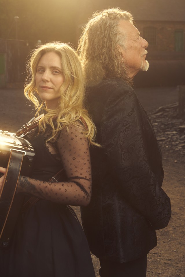 Robert Plant and Alison Krauss standing back to back in a press photo.
