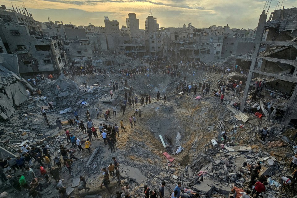 People search for casualties at the site of Israeli strikes on houses in Jabalia refugee camp.