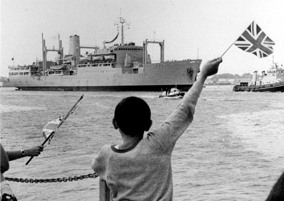 Child waving a Union Jack as the RFA Stromness arrives back from the Falklands War.