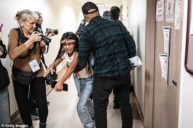 The woman's young daughter watched in tears as her mom was pushed to the floor