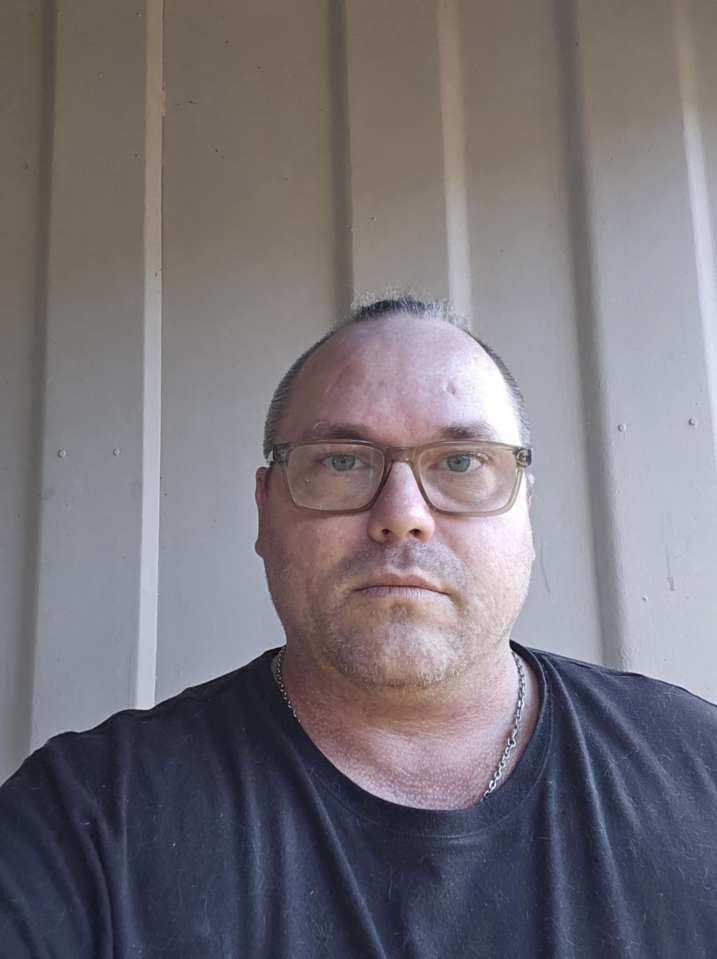 Photo of a man wearing glasses.