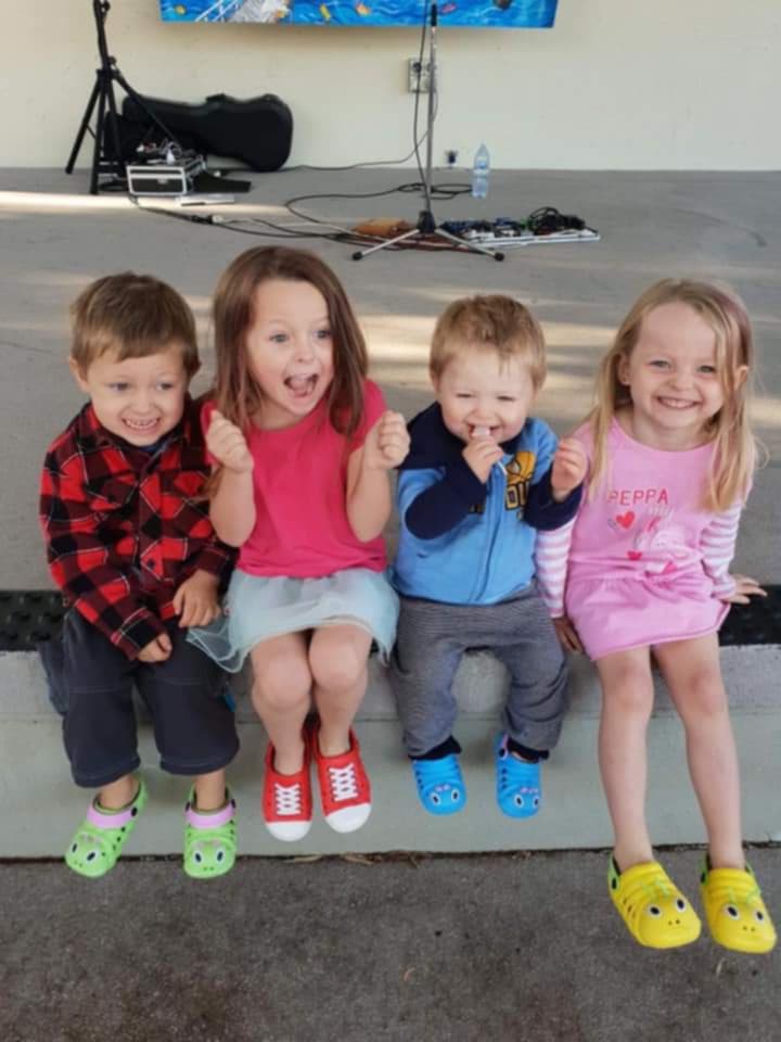 Four young children sitting together.