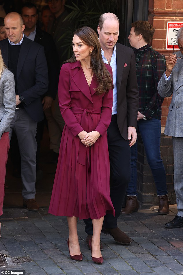During a 2023 visit to Birmingham, Kate opted for a burgundy Karen Millen trench dress. The polished design featured a pleated skirt and waist-defining belt, creating a feminine yet structured finish