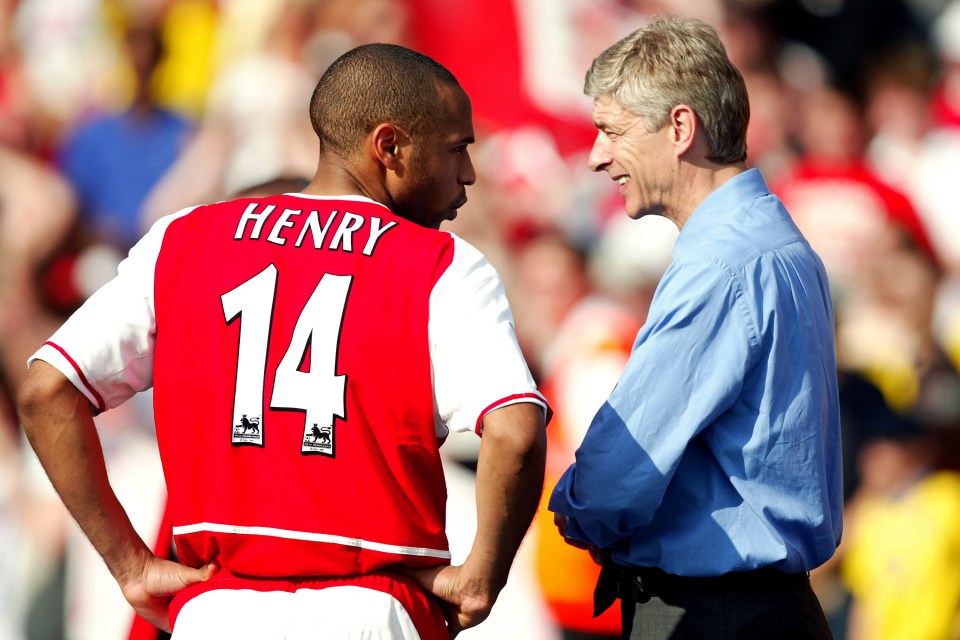Thierry Henry in an Arsenal jersey chatting with manager Arsene Wenger.