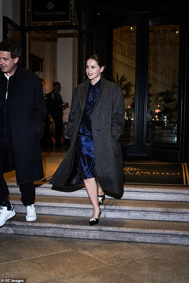 Elsewhere in Milan, Felicity Jones was spotted leaving her hotel in a blue satin midi dress