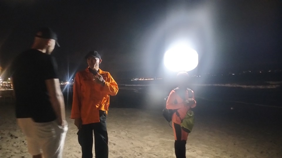 Rescue teams searching for a British tourist on Legian Beach, Bali.