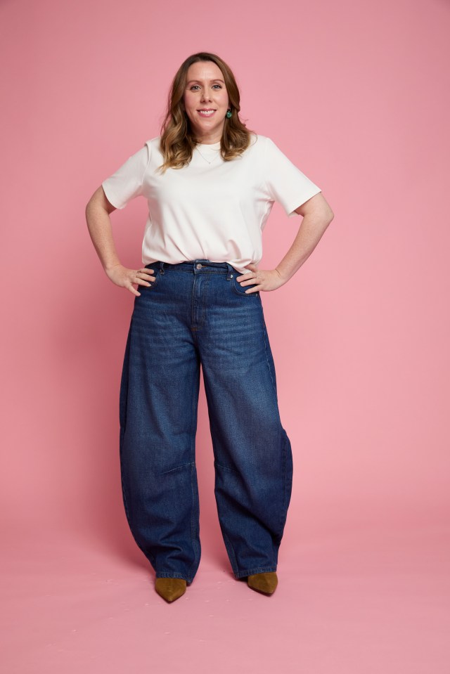 Sarah Morton wearing dark wash barrel jeans and a white t-shirt.