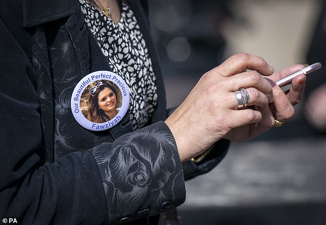 A family member wears a badge in memory of Fawziyah outside the High Court in Edinburgh