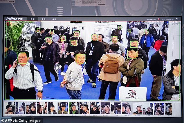 A screen shows visitors being filmed by AI (artificial intelligence) security cameras with facial recognition technology at the 14th China International Exhibition on Public Safety and Security at the China International Exhibition Center in Beijing on October 24, 2018