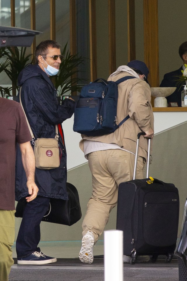 Liam Gallagher and his brother arriving at Luton Airport.