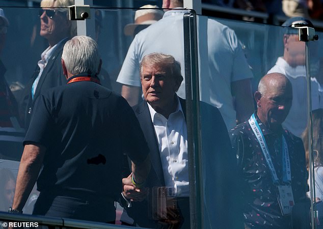 Trump took his place inside a box of perplex glass amid a wave of security fears at the event
