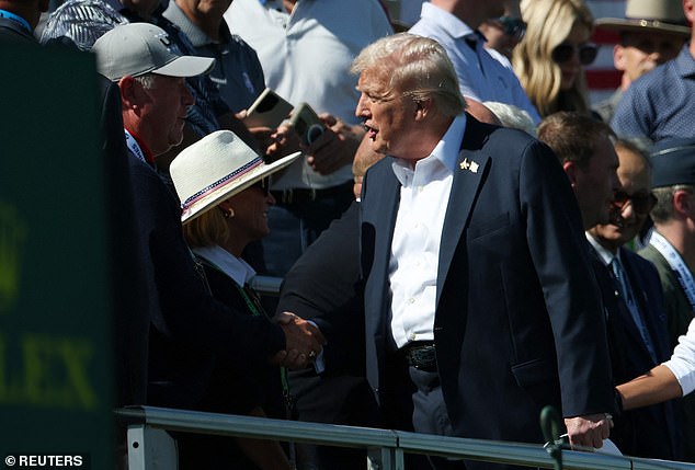 The president greeted a line of dignitaries as he arrived at the first tee grandstand
