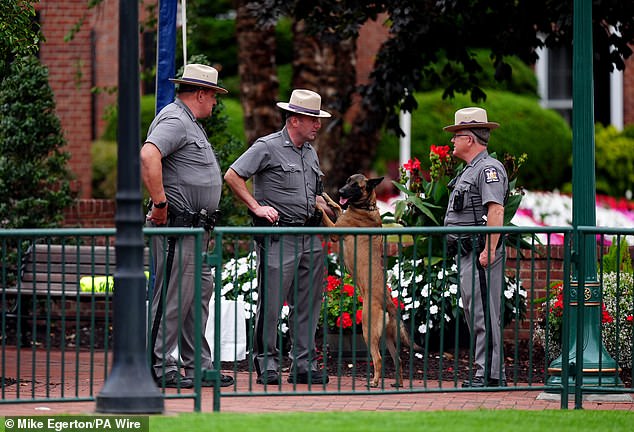 State troopers and secret service agents patrolled the restricted area with bomb sniffer dogs