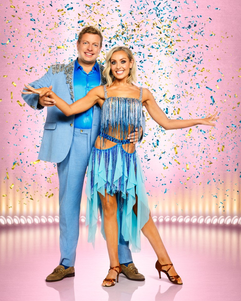 Tom Skinner and Amy Dowden in dance outfits on a stage with falling confetti.
