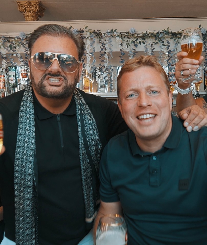 Robert Hisee wearing sunglasses and Tom Skinner smiling while holding beer glasses.