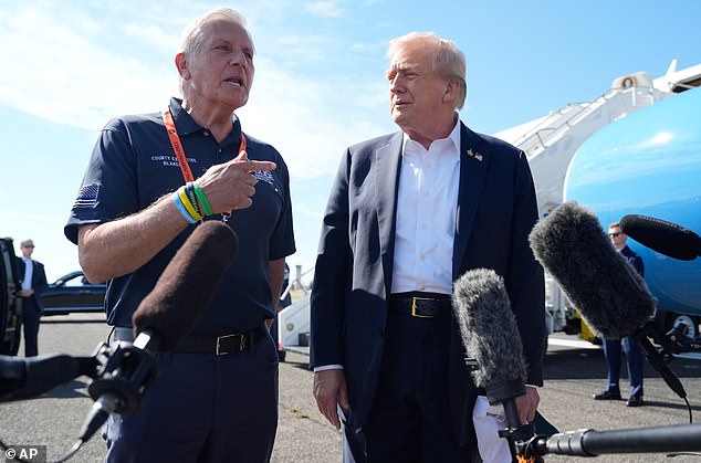 President Donald Trump listens as Nassau County Executive Bruce Blakeman speaks with reporters as Trump arrives on Air Force One at Republic Airport, Friday, Sept. 26, 2025, in Farmingdale, N.Y. (AP Photo/Alex Brandon)