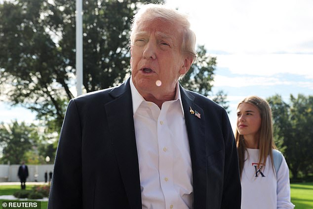 U.S. President Donald Trump speaks to the media as his granddaughter Kai Madison Trump looks on before departing for travel to New York to attend the Ryder Cup golf tournament, from the White House in Washington, D.C., U.S., September 26, 2025 REUTERS/Jonathan Ernst