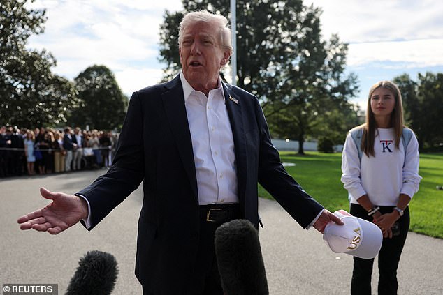 U.S. President Donald Trump speaks to the media as his granddaughter Kai Madison Trump looks on before departing for travel to New York to attend the Ryder Cup golf tournament, from the White House in Washington, D.C., U.S., September 26, 2025 REUTERS/Jonathan Ernst
