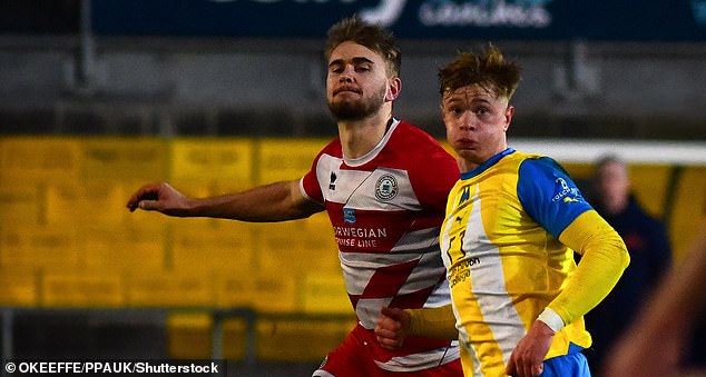 Vigar (left) pictured playing for Eastbourne Borough against Torquay United in 2024