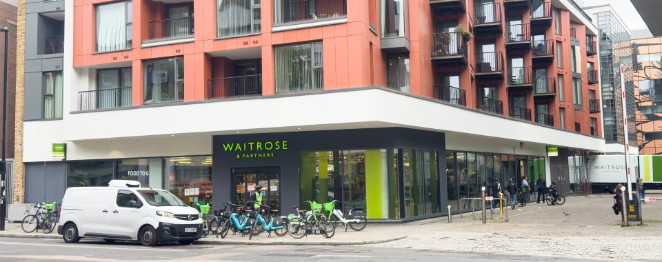 Waitrose store at 174 Saint John Street Clerkenwell with a white delivery van and parked bikes.