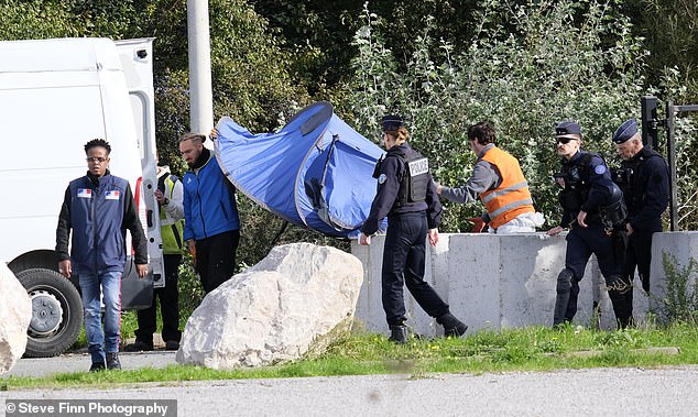 Multitudes of destitute and desperate men originating from across the world are in the French city of Calais, which increasingly resembles a giant refugee encampment. Pictured: French police raid a camp populated by Eritreans and Ethiopians in Calais