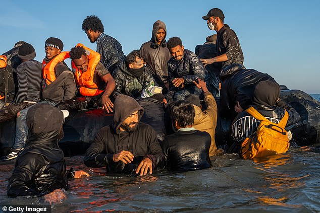 This week I watched as yet more people arrived, having fled or been driven out of other countries in Europe which are clamping down on them. Pictured: Migrants board a dinghy at Gravelines, France, to cross the English Channel on August 25, 2025