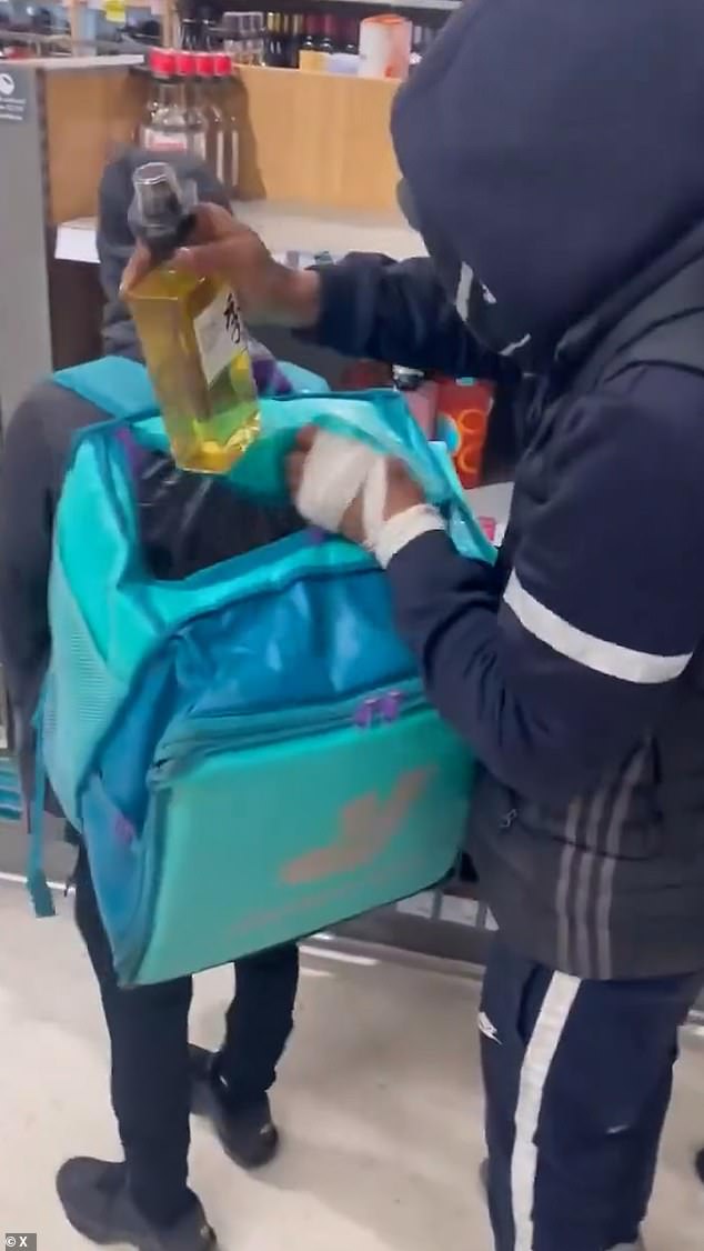 Shocking footage shows a pair of young men in hoods and balaclavas stealing at least 13 bottles in 45 seconds